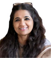 Ms. Sangita with long black hair with sunglasses, is smiling at the camera.