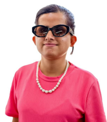 Image of Ms. Laxmi Nepal, wearing a pink color top with a pearl necklace and black color glasses.