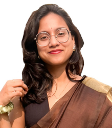 Image of Ms. Manjima Das, wearing a brown saree with a black blouse.