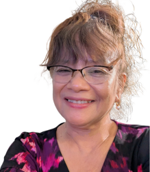 Ms. Veneranda Mateo, is wearing . a black and purple color top with a bun and specs