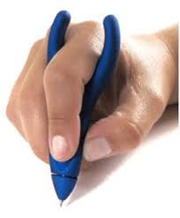 A person's hand holds a blue pen with a thick, ergonomic grip designed for easy holding. The fingers are wrapped around the pen, which has a distinct, curvy shape.