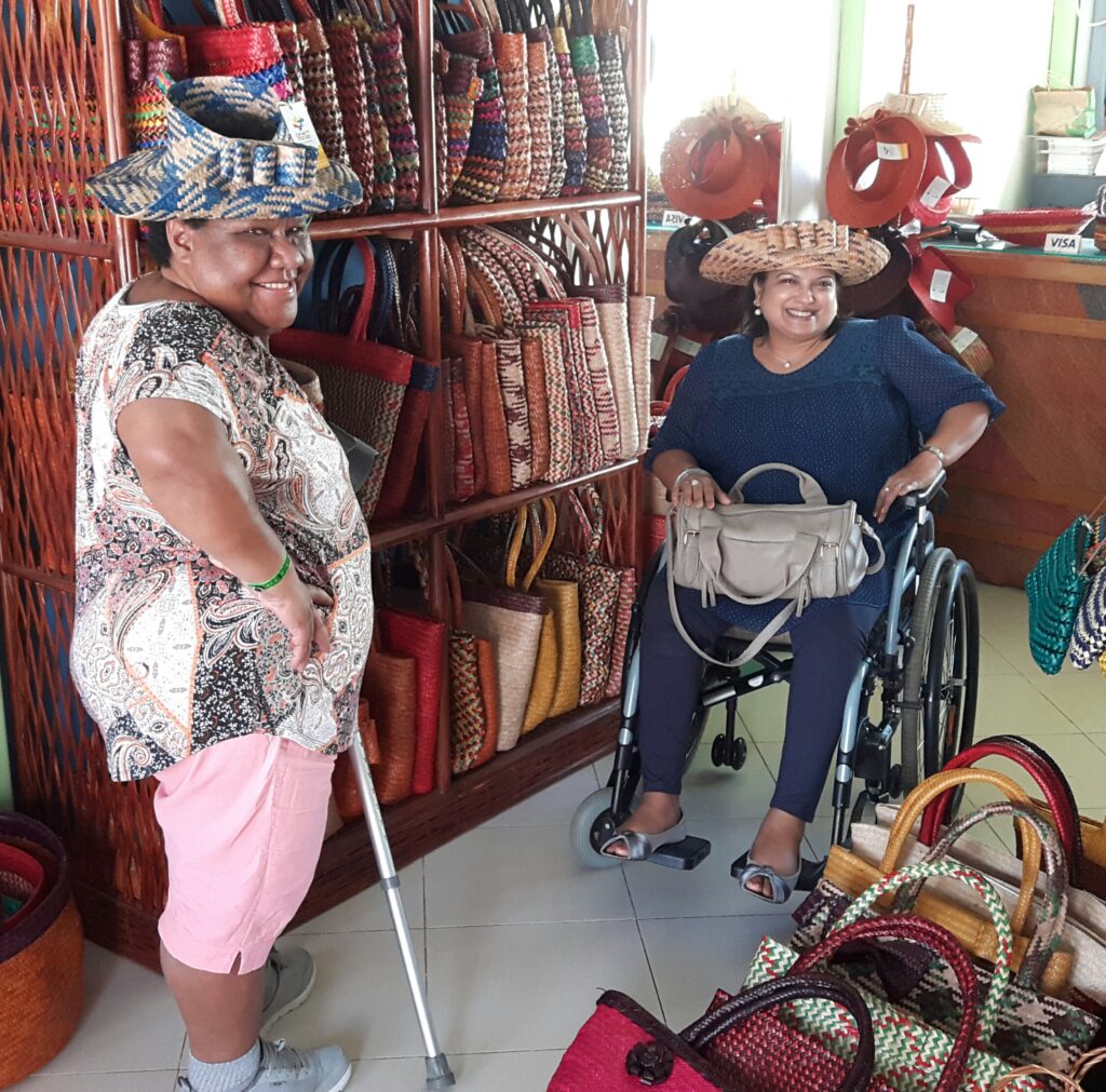 A wheelchair woman enjoying shopping wearing a hat