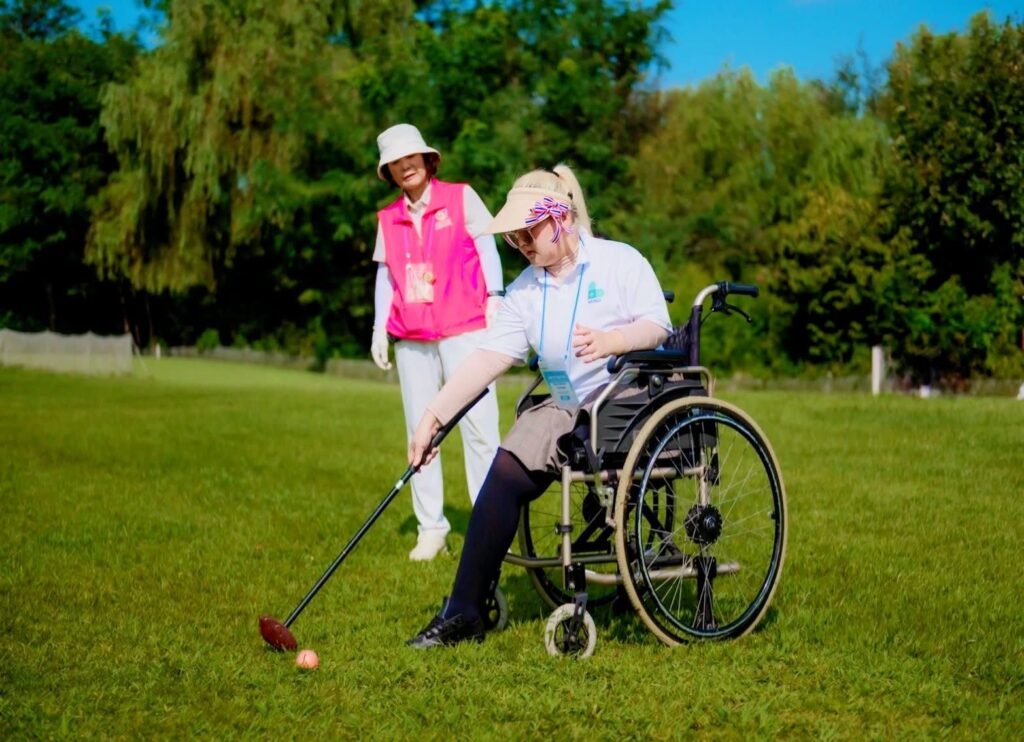 A wheelchair user playing golf